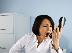 Businesswoman shouting at telephone. Image shot 2008. Exact date unknown.